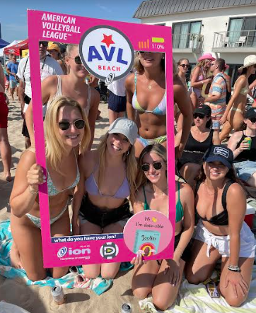 A group of women standing on top of a beach.