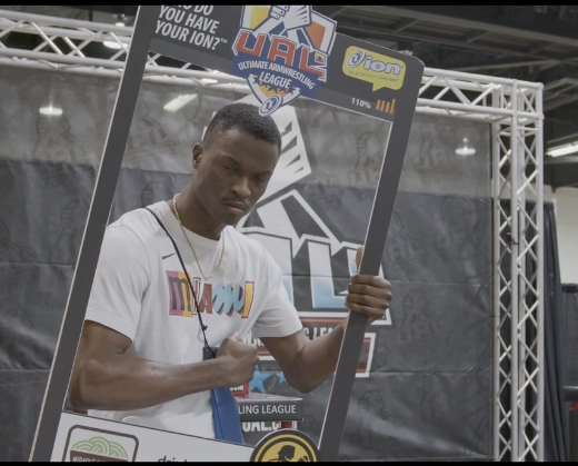 A man holding up a picture frame with the words " ubl " on it.